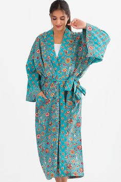 "Our Sangita Kimono Robes are hand block-printed on soft 100% cotton material by artisans in Rajasthan, India. The wooden blocks are first hand-carved and the design is then hand-stamped using a different block for each color in the pattern. The seamless printing shows the fine skill of the block-printers, and it is a craft that has been passed down from generation to generation. Each region of India has a different style of block-printing, and each family has their own collection of wooden blocks. These beautiful fair trade robes feature large pockets and contrast prints on the sleeves and placket, and are machine washable. One size fits most, 52\" length." Mermaid Candles, Gold Experience, Bath And Body Shop, Kimono Robes, Tie Length, Print Kimonos, Caftan Dress, Rajasthan India, Gold Pattern