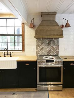 a stove top oven sitting inside of a kitchen