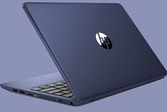 an open laptop computer sitting on top of a blue surface with the hp logo on it