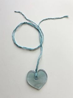 Handmade blue glass heart on hand sewn silk cord. Hearts measures approx. 2” across. Shape may vary slightly. Silk Cord Jewelry, Brooke Callahan, Blue Heart Necklace, Indie Craft, Red Choker, Tube Necklace, Icon Shoes, Rainbow Necklace, Daisy Earrings