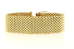 This chic woven linked bracelet is made in rich 14K Yellow gold. The piece is secured to the wrist via a box clasp and latch system. The bracelet measures 23mm wide, sits 2.48mm tall, and is of 7 inches in length.  B1848BIVPPD --Please reference our policy for more details before purchase--***For International orders, please provide a phone number for shipping purposes. Just place a note in the comment box during check out.Thank you.** Formal Gold Link Bracelet With Bracelet Strap, Formal Rectangular Bracelet, Luxury Link Chain Bracelet With Box Clasp, Luxury Yellow Gold Bracelets With Clasp, Luxury Gold Chain Bracelet With Clasp, Elegant Gold Link Bracelet With Clasp, Elegant Yellow Gold Chain Bracelet With Rectangular Shape, Elegant Gold Link Bracelet, Formal Yellow Gold Bracelets With Clasp