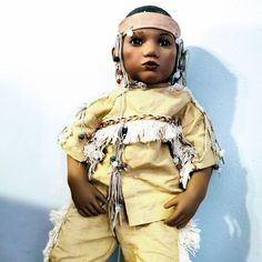 Annette Himstedt Takuma Native American Indian Doll 1995 This Dollis Part Of Annette Himstedt's 10th Anniversary Collection. She Represents A Little Cheyenne Girl. Takumi Is Designed To Be A Seated Doll. Her Head, Neck And Limbs Are Vinyl On A Weighted Cloth Body. Unlike Her Larger Himstedt Siblings, She Has No Armature To Hold A Pose, But Will Sit Demurely. She Measures 25.5" Tall, Head To Toe. Her Brown Eyes With Long Upper And Lower Lashes Are Stunning. She Has Great Coloring, Really A Pretty Doll.A Suede Band Decorated With Patterned Beads And Some Feather Fluff Encircles Her Head. Takumi Wears A Sweet 2 Pc. Outfit In A Peachy Shade Of Tan, Trim And More Leather Strings Holding More Be Tan Trim, Indian Dolls, Lower Lashes, 10 Anniversary, 10th Anniversary, Native American Indians, American Indian, Brown Eyes, Doll Accessories