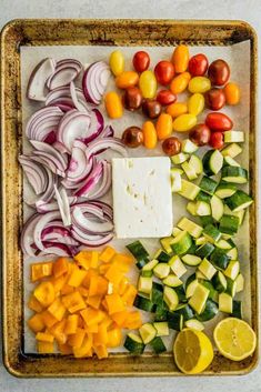 an assortment of vegetables on a tray ready to be cooked