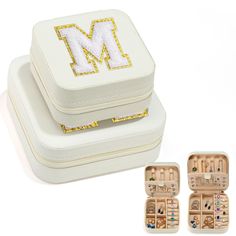 two white jewelry cases with the letter m on them