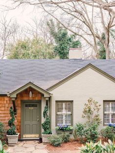 a house that has some plants in front of it