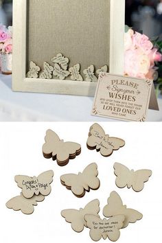 there are some wooden butterflies on the table and in front of it is a sign that says, i love you