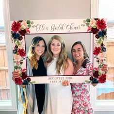 three women pose for a photo in front of a floral frame with the words, ella bridal power on it