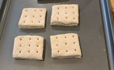 four square crackers on a baking sheet