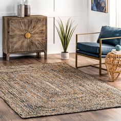 a living room with a rug and chair