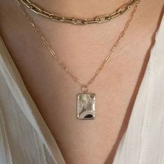 The 14k gold CAVE is a medium rectangular pendant with the signature JB brushed satin with shiny accents on the edge. The three sparkling rainbows of white diamonds highlight the piece. Available as pendant only, or with our recommended chain. Additional chain options available in our Chains & Chokers collection. Chain shown is 14k gold 1.8mm diamond cut ball chain Recommended chain lengths are 16" or 18" Full cut round white diamonds, approx .31ctw Dimensions are approximately 20mm x 14mm Desig Gold Jewelry With Rectangular Polished Stone, Gold Jewelry With Polished Finish And Rectangular Stone, Fine Jewelry Everyday Rectangular Pendant, Everyday White Gold Rectangular Pendant Jewelry, Everyday Fine Jewelry With Rectangular Pendant, Gold Diamond Jewelry With Rectangular Stone, Minimalist Diamond Rectangular Pendant Jewelry, Rectangular Diamond Jewelry For Everyday Luxury, Everyday Luxury Rectangular Diamond Jewelry