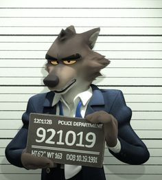 a man in a suit and tie holding a sign with a wolf on it's face