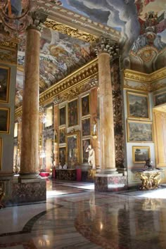 an ornate room with paintings on the walls