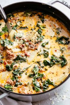 spinach and cheese casserole in a skillet with a ladle on the side