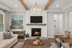 a living room filled with furniture and a flat screen tv mounted on the wall above a fire place