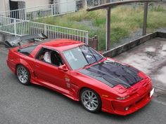 a red sports car parked in front of a building