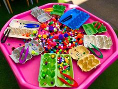 a pink table topped with lots of plastic toys