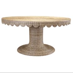 a wicker table with scalloped edges on an isolated white background for display