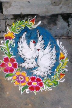 two white doves with flowers painted on the ground