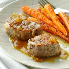 a white plate topped with meat and carrots