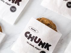 three bagged cookies sitting on top of each other next to paper bags that say chunk