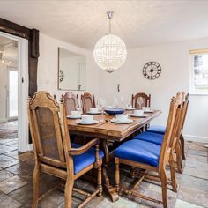 a dining room table with blue chairs around it