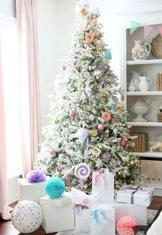 a flocked Christmas tree decorated with pastel ornaments, candy and donut shaped ones, with lights Xmas Ornaments Diy, Hot Cocoa Ornaments, Themed Christmas Tree, Round Gift Boxes, Candy Christmas Tree, Holiday Home Tour