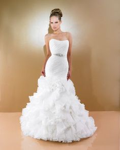 a woman in a white wedding dress posing for the camera