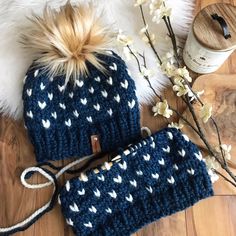 two knitted hats on top of a wooden floor