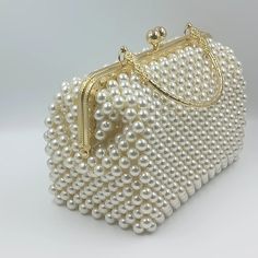 Introducing the stunning ivory pearl beaded bag, meticulously handcrafted with love and passion by an Indian artisan using premium faux pearls.  This show-stopping golden top handle bag is destined to capture all eyes and it fits iPhone 15 Pro Max very easily along with other normal stuff and its inner perfect ivory lining makes it non-transparent. More than just a stylish accessory, the medium sized bag is a perfect gift for a myriad of occasions - birthdays, Valentine's Day, anniversaries, Mot Handmade Pearl Bag, Pearl Bags Purses, Kaftan Art, Beads Bags Handmade, Golden Purse, Pearl Beaded Bag, Golden Clutch, Pleasure Principle, Pearl Bags