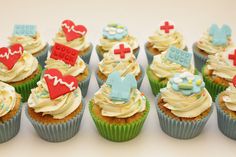 cupcakes with icing and decorations on them are arranged in the shape of hearts