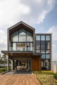 a large house with lots of windows on top of the roof and wooden decking