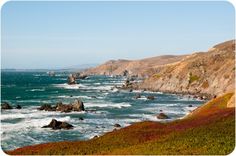 the ocean is full of waves and rocky coastlines on a sunny day in california