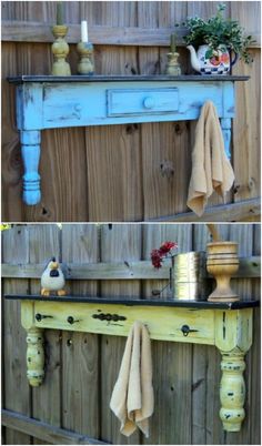 an old table is painted blue and yellow with some flowers on the shelf next to it