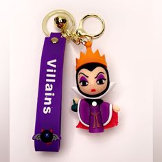 a keychain with an evil queen on it and a name tag attached to it