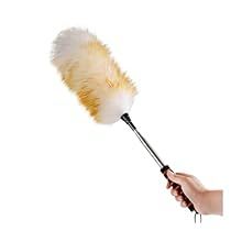 a hand holding a white and yellow feather duster