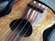 an ukulele is laying on the floor with its strings still attached to it