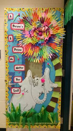 a bulletin board with an elephant and flowers on it