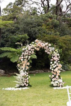 an outdoor ceremony setup with flowers and greenery