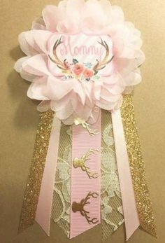 a pink and gold ribbon with some flowers on it's side that says mommy