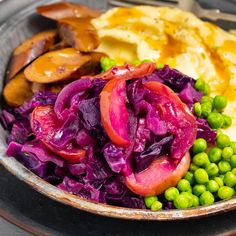 a bowl filled with vegetables and potatoes on top of a table