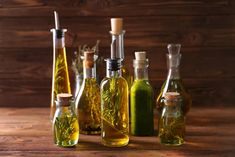 several bottles filled with different types of olive oil