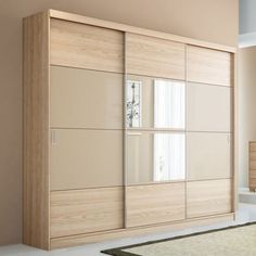 an empty room with a large wooden cabinet and rug on the floor in front of it