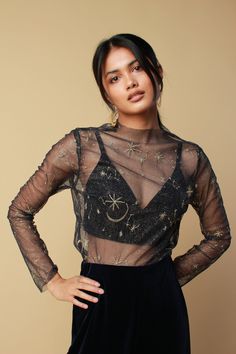 "The black mesh top features a high neck complete with embroidered celestial stretch fabric. Perfect to pair with our wide leg velvet trousers or slip stain dress for your next festival night out. Available in sizes S,M,L: SMALL- UK 6-8 Measurements: bust 36\", sleeve 5\", sleeve length 17\" MEDIUM - UK 10-12 Measurements: bust 40\", sleeve 7\",sleeve length 17\" LARGE- UK 14-16 Measurements: bust 44\", sleeve 9\",sleeve length 17\" Aya is a size 6 and wears a SMALL. - CUSTOM SIZES AVAILABLE UPO Mesh Top Outfit, Black Mesh Top, Velvet Trousers, Concert Fits, Top Outfit, Halter Neck Top, Full Sleeves, Etsy Fashion, Green Velvet