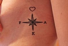 a compass tattoo with a heart on it