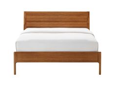 a bed with a wooden frame and white sheets