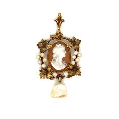 From victorian era, this lavalier cameo with beautiful silhouette of a woman features seed pearls and figural leaf and twig around the cameo. The off shape pearl dangles at bottom of the pendant. Measurement: 3/4 x 1 1/2 inch Gross Weight: 2.7 grams Elegant Antique Gold Cameo Necklace, Gold Cameo Jewelry In Art Nouveau Style, Elegant Cameo Necklace For Vintage Events, Elegant Vintage Necklace With Brooch, Vintage Baroque Cameo Jewelry, Elegant Vintage Brooch Necklace, Elegant Antique Gold Cabochon Necklace, Elegant Cameo Jewelry For Vintage Events, Elegant Vintage Camo Jewelry