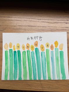 a happy birthday card with green candles on the front and yellow ones on the back