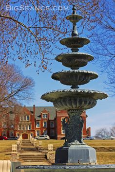 a water fountain in the middle of a park