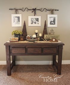 a table with pictures on the wall above it