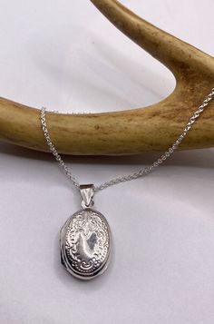 "Vintage Silver Locket Necklace  The Tiny Oval Photo Locket measures about 1/2 inch long (without the bale), features a lovely etched design and is the perfect necklace for a small photo or other memory  Paired with a delicate 925 Sterling Silver Chain available in lengths of 16, 18 ,20, 22\" or 24\" We recommend using a laminated photo for longevity  Thank you for supporting a small veteran owned business! All jewelry is shipped free within the US in a stylish gift box" Sterling Silver Locket Necklace With Oval Link For Gifts, Classic Oval Pendant Jewelry With Engraving Option, Sterling Silver Oval Locket Necklace Gift, Silver Oval Pendant Jewelry With Engraving Option, Silver Oval Pendant Necklace With Engraving Option, Silver Oval Pendant Necklaces With Engraving Option, Silver Jewelry With Engraving Option, Oval Pendant, Classic Engraved Locket Necklace With Oval Link, Antique Silver Sterling Silver Oval Locket Necklace